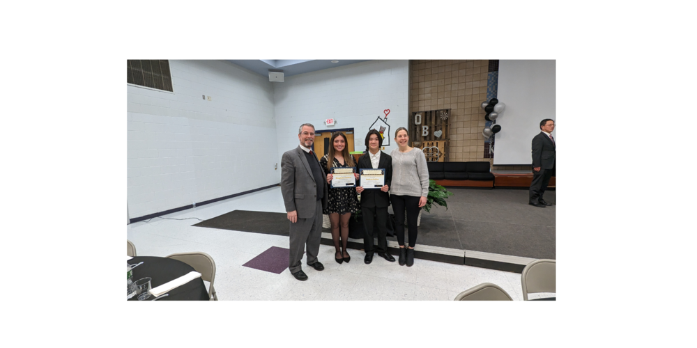 Picture of Mr. Lassiter, two high school students and Dr. Nicosia at the Unsung Heroes event celebrating the students' accomplishments.