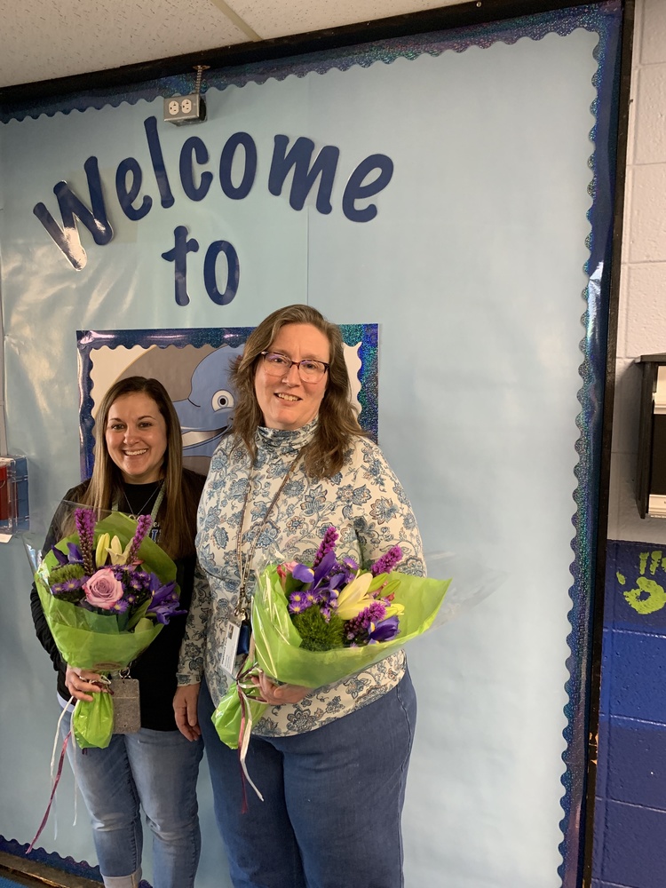 Mrs. Mayo and Mrs. Kershaw holding flowers